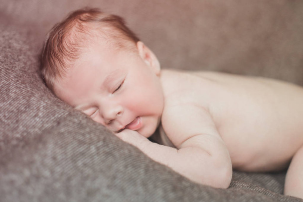 Newborn baby boy lying on his bad relaxing at home - Fotoğraf, Görsel