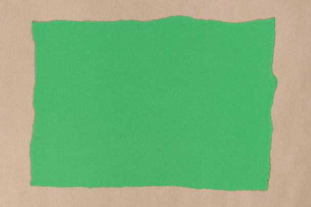 green piece of torn paper on recycled paper background texture - Φωτογραφία, εικόνα