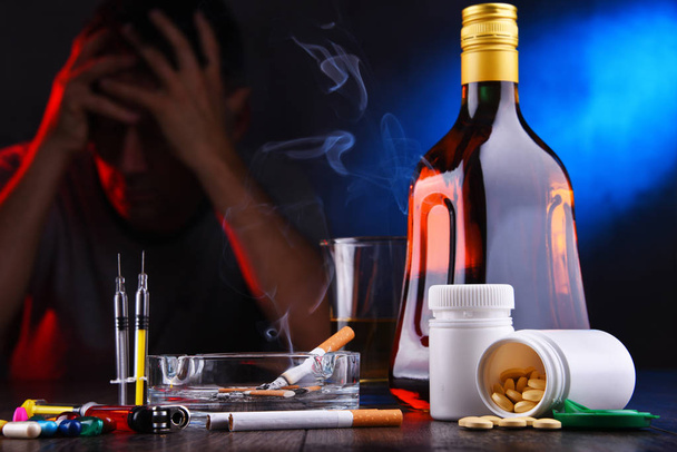Addictive substances and the figure of a addicted man - Foto, imagen