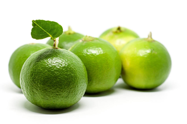 Green lime on white background for food ingredients and cooking concept - Photo, Image