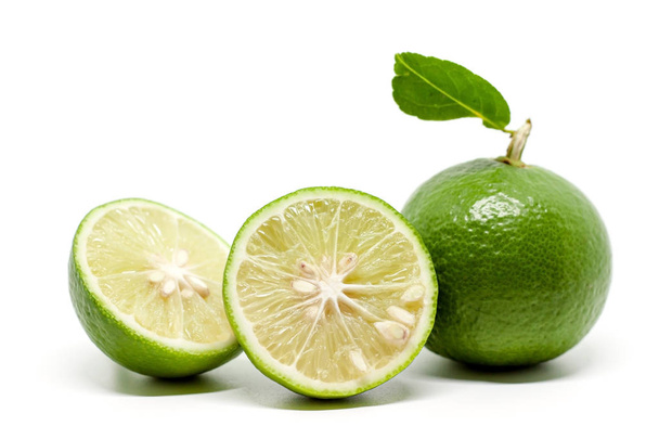 Green lime on white background for food ingredients and cooking concept - Fotoğraf, Görsel