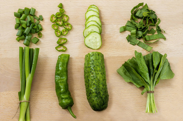 Sliced green vegetables on a cutting board. Top view - Φωτογραφία, εικόνα