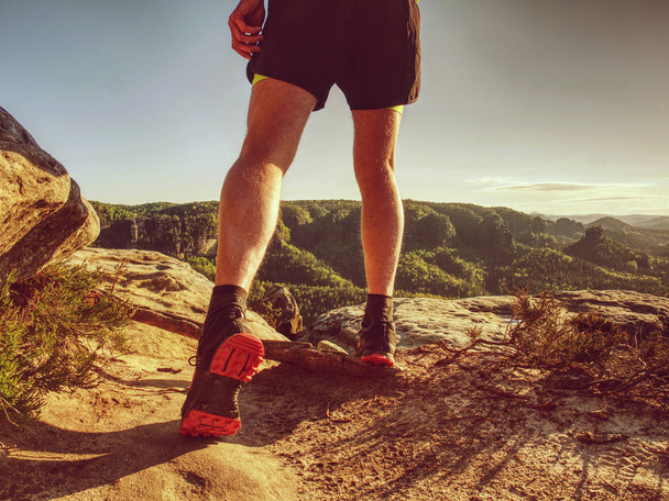 Trail runner in natural terrain, body contour in low ankle view - Photo, Image
