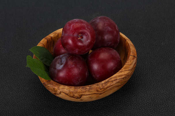 Plum heap in the wooden basket - Photo, image