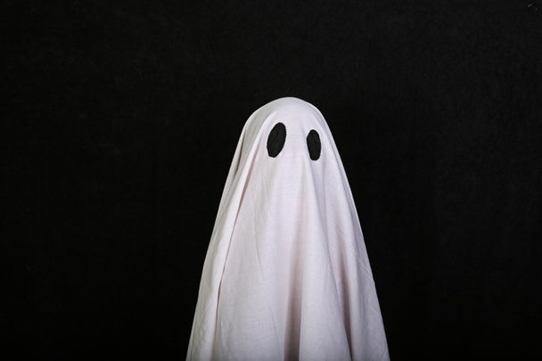 White Ghost on black background. Halloween holiday party. - Photo, Image