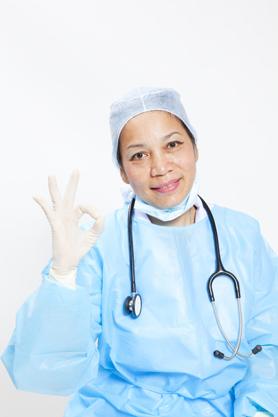 Asian doctor give you an ok gesture, closeup portrait on white background. - Photo, Image