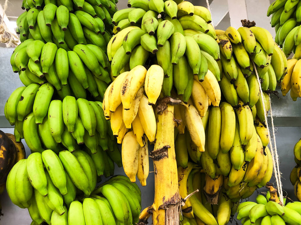 Bananas hanging in a supermarket in Bora Bora, The Society Islands, French Polynesia - Photo, Image