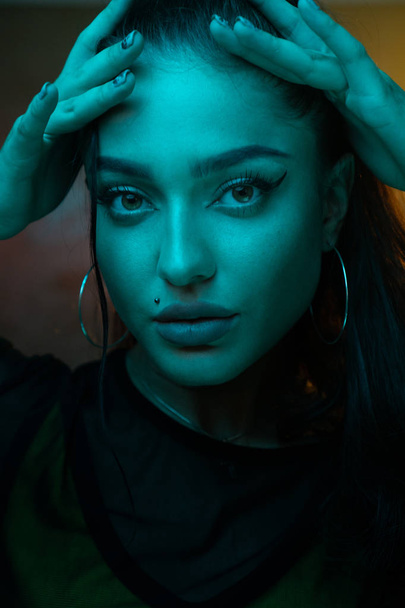 Sensual woman neon lights portrait. Beautiful young female model in neon lights image - Fotó, kép
