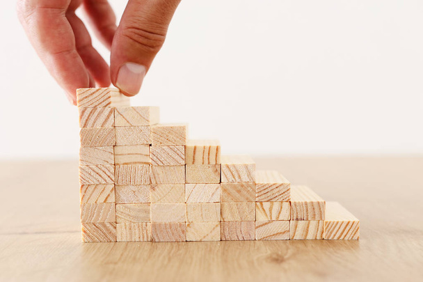 Business image of arranging wood blocks stacking as step stairs. Success and development concept - Fotoğraf, Görsel