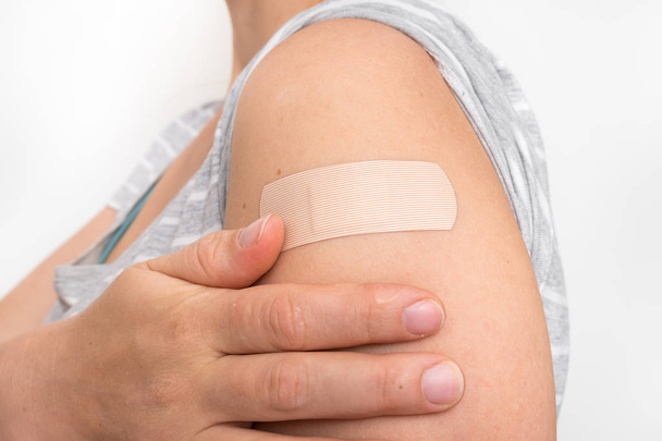 Woman with adhesive bandage on her shoulder  - Φωτογραφία, εικόνα