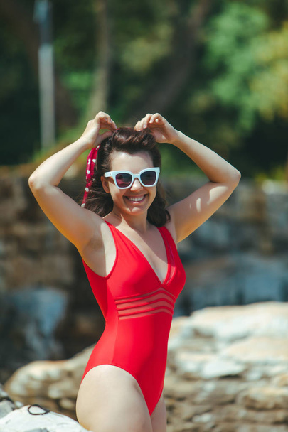 smiling pretty sexy woman in red swimming suit - Fotó, kép