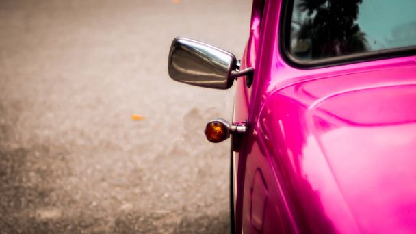 Side mirror and window of beautiful vintage pink car over blur background - Φωτογραφία, εικόνα