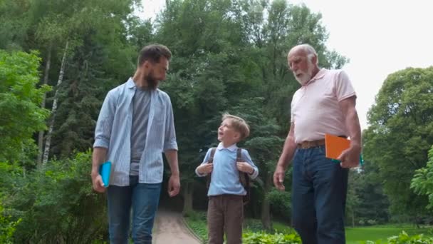 Family Generations concept: Father, son and Granddad, outdoors, in Nature, enjoying their Quality Time together, All in nice wear take child to school. - Footage, Video