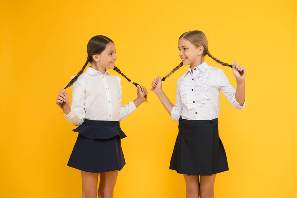 Education is step by step process of getting knowledge. Classmates having fun at school. Friends adorable pupils. Schoolgirls formal style school uniform. Happy childhood. School education concept - Valokuva, kuva