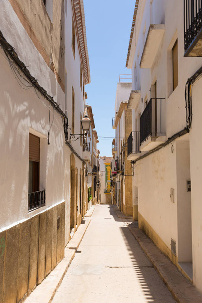 Narrow street in the old town Xabia Spain - 写真・画像
