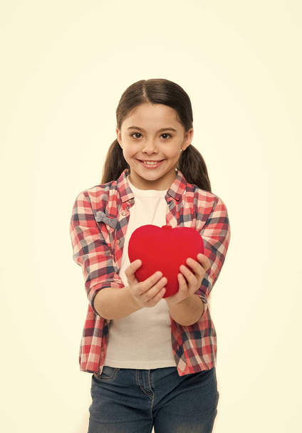 Me to you. Greeting from sincere heart. Girl cute child hold heart symbol love. Celebrate valentines day. Love and romantic feelings concept. Red heart attribute of valentine. Heart gift or present - Фото, изображение