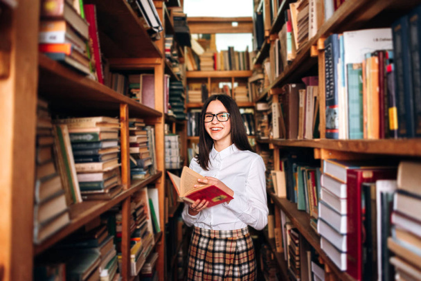 Cute teenage girl posing in library - Photo, Image