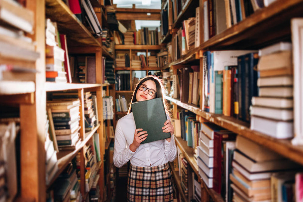 Linda adolescente posando en la biblioteca
 - Foto, Imagen