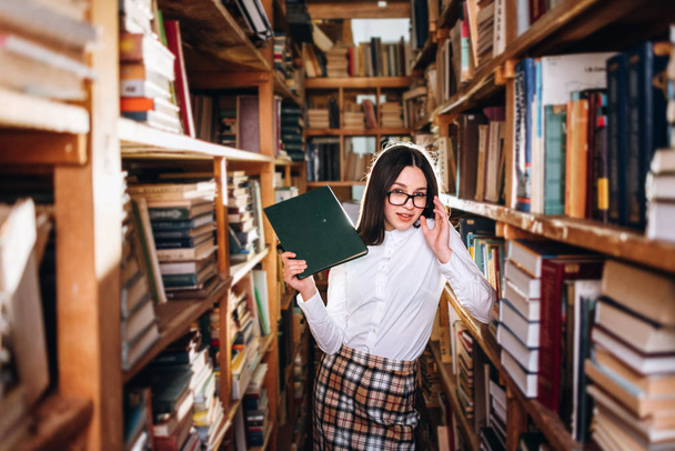 Carino adolescente in posa in biblioteca
 - Foto, immagini