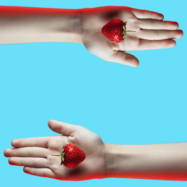 collage of bright juicy strawberries in hand on blue background - Zdjęcie, obraz