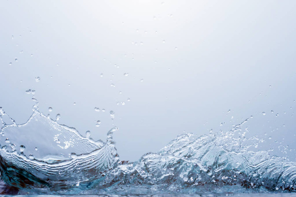 Splash water on blue background - Фото, зображення