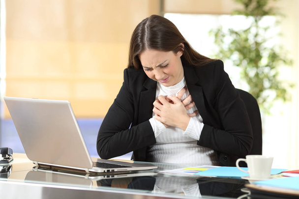 Young businesswoman suffering chest ache at office - Photo, Image