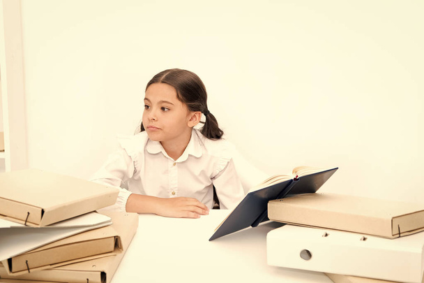 Get rid of boring task. Girl bored pupil sit at desk with folders and books. Issues of formal education. Back to school concept. Kid cute tired of studying. Boring lesson. Boring task homework - Valokuva, kuva