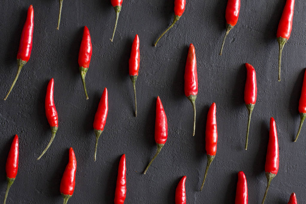 Red Hot Chili Peppers On Black Dark Background on Black Table. A - Photo, image