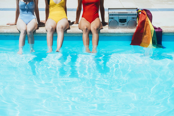 Friends playing in the pool on a sunny summer day - 写真・画像
