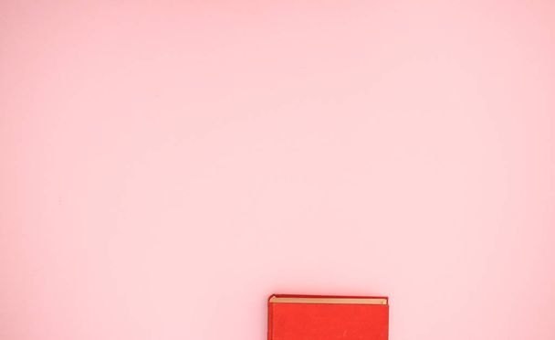 Red book on pink background  - Zdjęcie, obraz