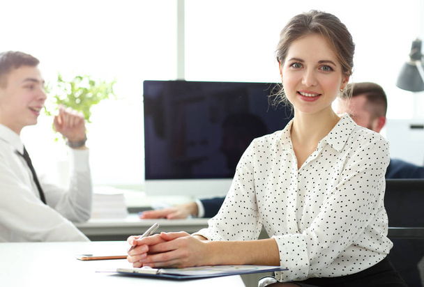 Young beautiful smiling clerk in office looking in camera - Photo, Image