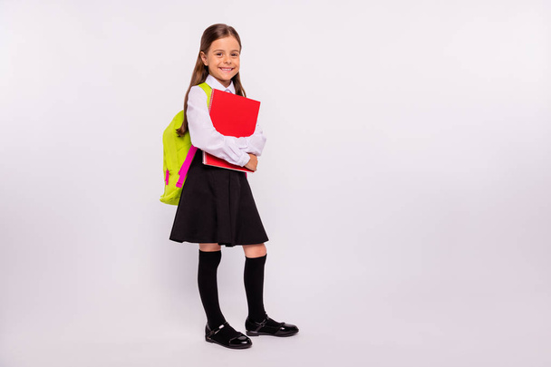 Full length body size view portrait of her she nice attractive lovely cheerful cheery pre-teen girl holding in hands exercise book isolated over light white grey background - Фото, зображення