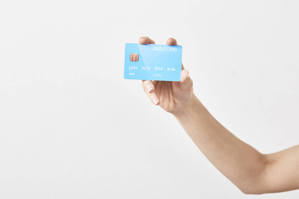 Credit card in hand on white - Фото, изображение