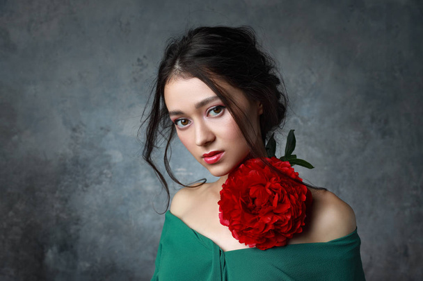 beautiful young european girl looking asian with peon flowers - Photo, image