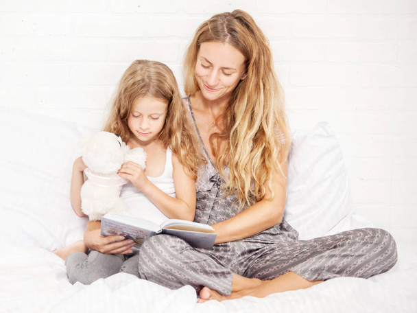 Woman with child reading book - Photo, Image