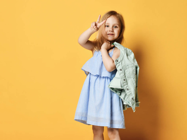 Full length portrait of a cute little child girl in a stylish dress and denim. - Foto, afbeelding