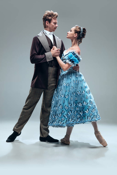 Contemporary ballroom dancers on grey studio background - Фото, зображення