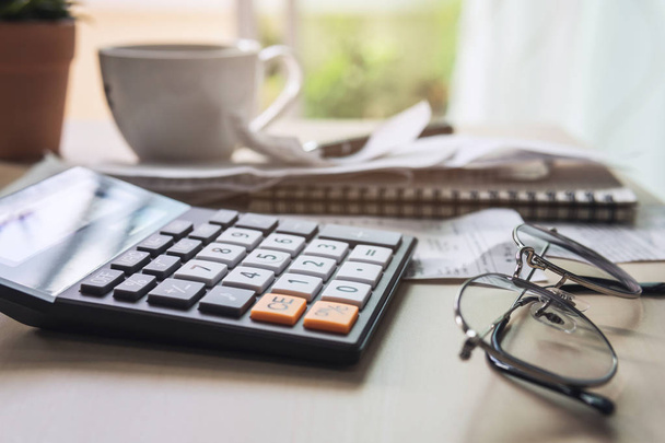 calculator with bills, taxes, bank account balance and calculati - Φωτογραφία, εικόνα