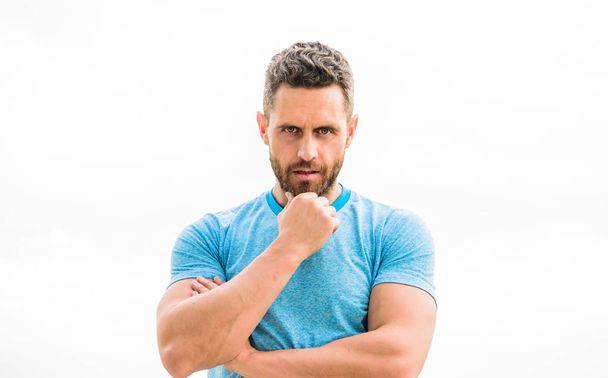 man athlete in blue sport tshirt. sportswear fashion. muscular male with beard. thoughtful man isolated on white. sportsman with athletic body. coach in fitness gym. after workout. Relax after train - Valokuva, kuva