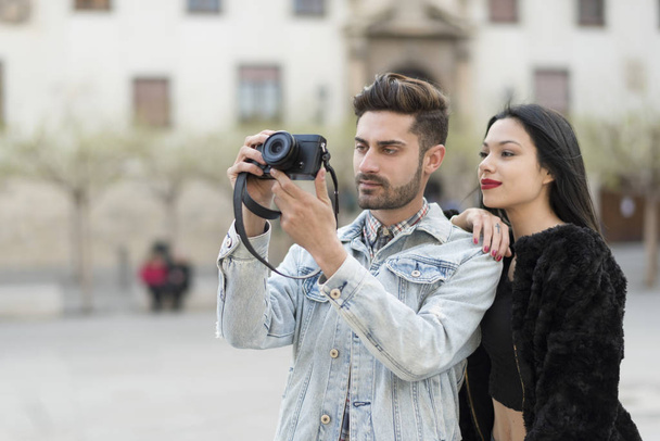 Young couple taking pictures in city outdoors at european travel - Zdjęcie, obraz