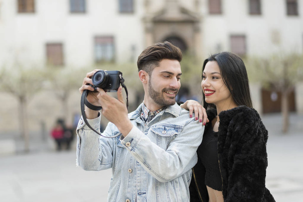 Young couple taking pictures in city outdoors at european travel - Φωτογραφία, εικόνα