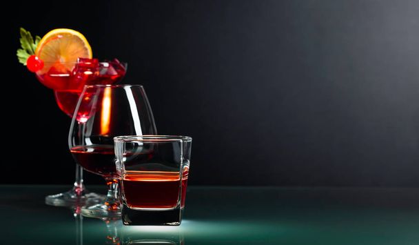 Various alcoholic drinks on a black background. - Photo, image