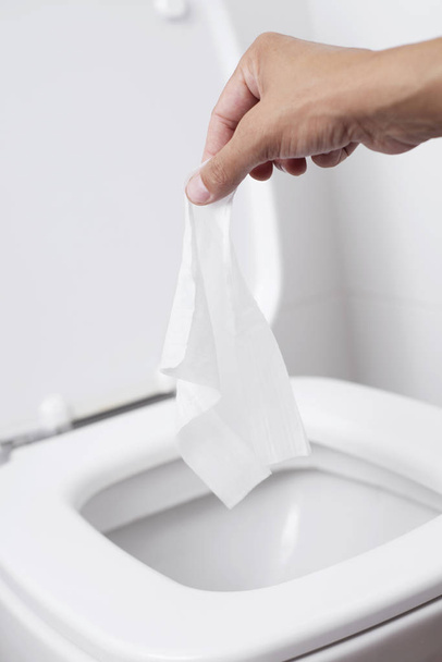 man throwing a wet wipe to the toilet - Photo, Image