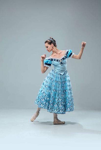 Contemporary ballroom dancer on grey studio background - Фото, зображення