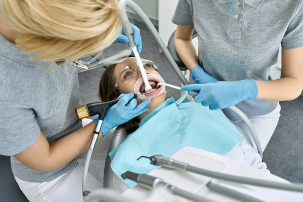 Pretty womans teeth cleaning in dental clinic - Фото, изображение