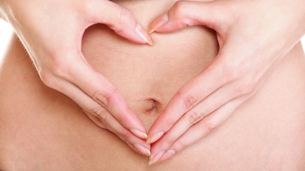 Sexy young woman heart shape hands belly - Фото, зображення