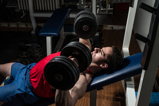 Young bodybuilder doing bench press for chest - Fotoğraf, Görsel