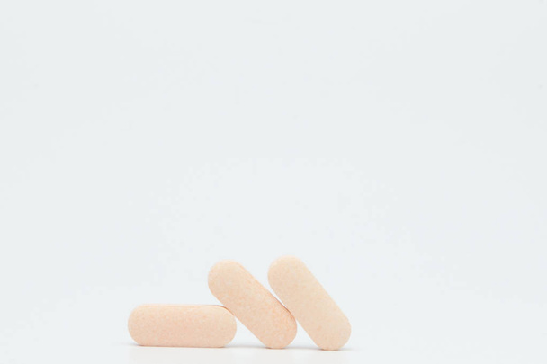 Macro view of pill or tablet isolated over white background - Foto, afbeelding