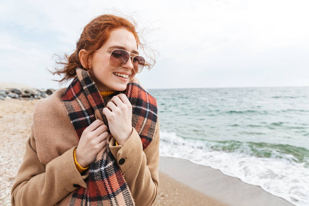 Lovely young redhead woman wearing autumn coat - Foto, immagini