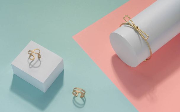 Золотой браслет и два золотых кольца на розовом и зеленом фоне
 - Фото, изображение